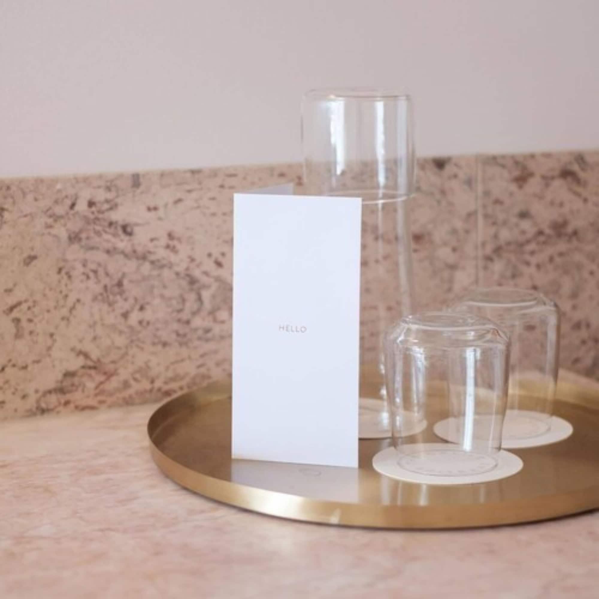 The Calile Hotel Brisbane Extérieur photo A tray of water and glasses at a hotel